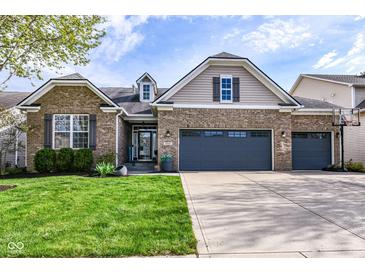 Charming brick home with a three car garage and well-maintained landscaping at 6625 W Winding Bnd, McCordsville, IN 46055
