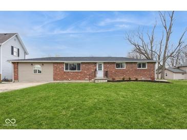 Charming single-story brick home with a well-manicured lawn at 828 N 13Th St, Elwood, IN 46036