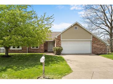 Charming single-story home with a brick facade, an attached two-car garage, and a well-manicured lawn at 1170 Runningbrook Dr, Avon, IN 46123