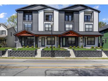Modern townhome showcasing gray and white exterior, small balconies, and well-maintained front yard at 2226 Central Ave, Indianapolis, IN 46205