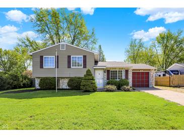 Charming two-story home with stone accents, manicured lawn, and attached garage on a sunny day at 251 Yorktown Rd, Greenwood, IN 46142