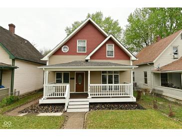 Charming two-story home with a covered front porch and nicely landscaped yard at 344 N Addison St, Indianapolis, IN 46222