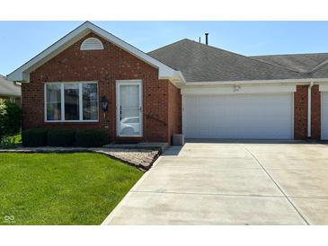 Charming brick home featuring an attached two-car garage and well-maintained front lawn at 379 Vinewood N Dr, Brownsburg, IN 46112