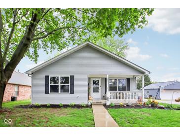 Charming single-story home with a covered front porch and well-maintained lawn and tidy landscaping at 709 S Meridian St, Lebanon, IN 46052