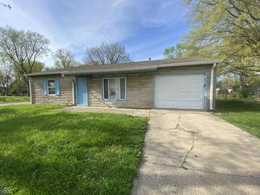 Charming single Gathering home with stone facade, attached garage, and inviting front yard at 9048 E 36Th St, Indianapolis, IN 46235