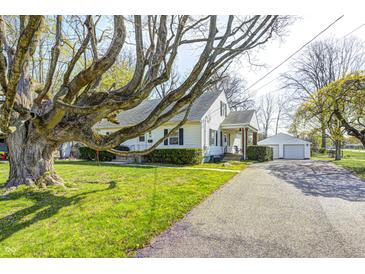 Charming home showcasing a well-maintained lawn, mature trees, detached garage, and a cozy front porch at 333 N Jefferson St, Brownsburg, IN 46112