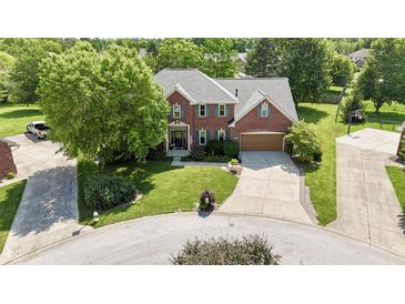 A lovely brick home with a large manicured lawn and mature trees in a peaceful cul-de-sac neighborhood at 3601 Lakeshore Ct, Greenwood, IN 46143