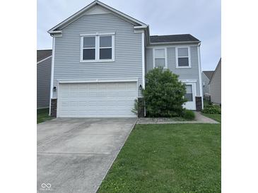 Charming two-story home with light gray siding, a white garage door, and manicured lawn at 4070 Presidio Cir, Indianapolis, IN 46235