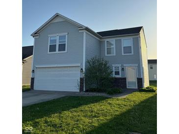 Charming two-story home with attached garage and well-maintained front lawn at 4070 Presidio Cir, Indianapolis, IN 46235