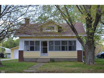 Charming yellow home with brick accents and a cozy front porch at 4736 Madison Ave, Indianapolis, IN 46227