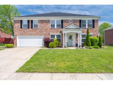 Charming two-story brick home featuring a well-manicured lawn and welcoming front porch at 5422 Portman Dr, Noblesville, IN 46062