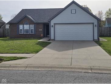 Charming single-story home with a brick accent, light blue siding and a two car garage at 6431 Furnas Rd, Indianapolis, IN 46221