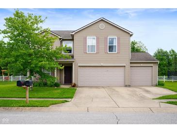 Charming two-story home with a three-car garage, well-maintained lawn, and inviting curb appeal at 8211 Firefly Way, Indianapolis, IN 46259