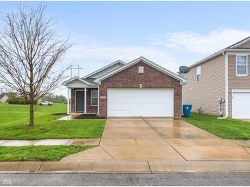 Charming single-Gathering home with brick facade, attached two-car garage, and well-maintained lawn at 11327 Cuyahoga Dr, Indianapolis, IN 46235
