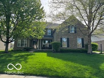 Charming two-story home with a well-manicured lawn and mature trees providing shade at 12353 Brean Way, Fishers, IN 46037