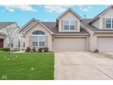 Charming home with a two-car garage, manicured lawn, and beautiful brick and vinyl siding at 12698 Whisper Way, Fishers, IN 46037