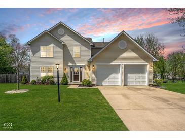 Charming two-story home with a well-manicured lawn and attached two-car garage at 18811 Orleans Ct, Noblesville, IN 46060