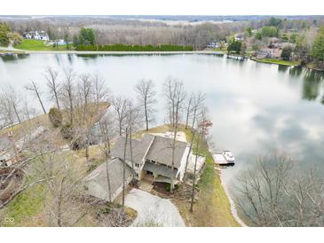 Stunning aerial view of waterfront home, lush landscape, and serene lake, perfect for peaceful living at 2001 E Ely Ct, Martinsville, IN 46151
