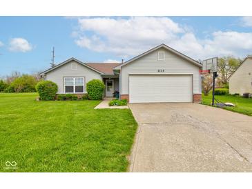 Charming single-story home featuring a two-car garage, well-maintained lawn, and lovely landscaping at 2125 Jason Dr, Lebanon, IN 46052