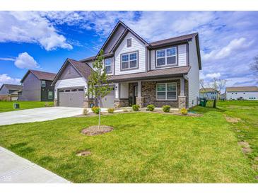 Beautiful two-story home featuring a manicured lawn, brick accents, and a two-car garage at 3148 Hawking Ct, Danville, IN 46122