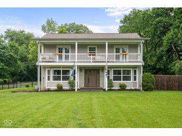 Charming two-story home with a spacious porch, well-maintained lawn, and beautiful curb appeal at 4904 Kessler Blvd N Dr, Indianapolis, IN 46228