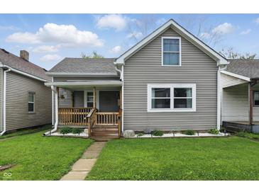 Charming home featuring a covered front porch, manicured lawn, and neutral siding at 842 Miller Ave, Shelbyville, IN 46176
