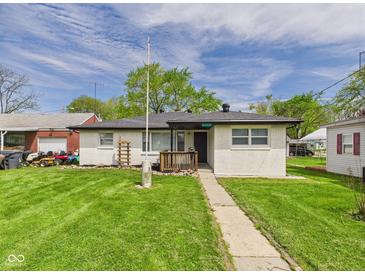 Charming single-story home with a well-maintained lawn, inviting entrance and a painted brick exterior at 108 W Cross St, Anderson, IN 46012