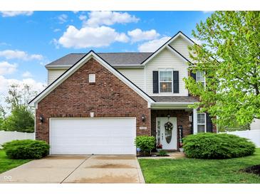 Charming two-story brick home with an attached garage and well-manicured lawn at 1141 Lazio Ct, Greenwood, IN 46143