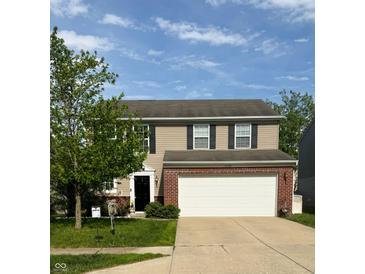 Charming two-story home with a well-maintained lawn and a spacious two-car garage at 15406 Destination Dr, Noblesville, IN 46060