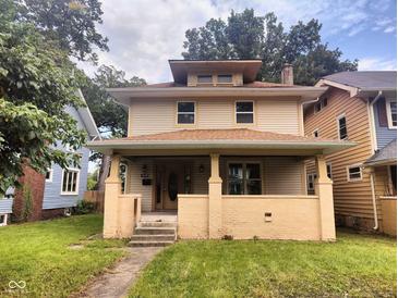 Charming two-story home with a covered front porch and landscaped front yard at 3629 Birchwood Ave, Indianapolis, IN 46205