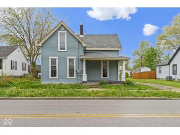 Charming two-story home with a covered front porch and light blue siding at 524 S State St, Greenfield, IN 46140