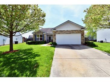 Charming single-story home with a manicured lawn, a stone facade, and an attached two-car garage at 5809 Scotland St, Indianapolis, IN 46234
