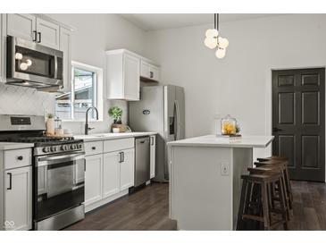 Well-designed kitchen featuring stainless steel appliances, white cabinetry, and a functional island at 629 N Keystone Ave, Indianapolis, IN 46201