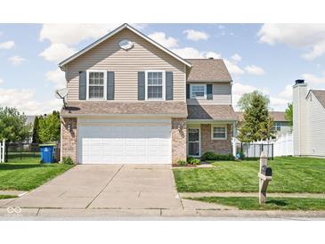 Charming two-story home featuring a two-car garage and a well-manicured front lawn in a suburban neighborhood at 6842 Viola Ct, Indianapolis, IN 46237