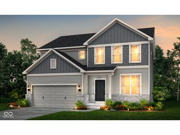 Charming two-story home boasts gray siding, stone accents, and a two-car garage at 6871 Seabiscuit Rd, Whitestown, IN 46075