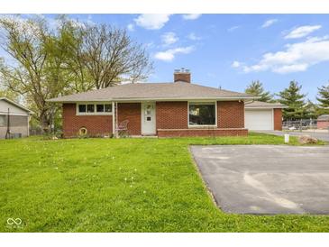 Charming single-story brick home featuring a well-maintained lawn, detached garage and long private driveway at 70 Casco Dr, Avon, IN 46123