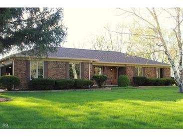 Charming single-story brick home with a well-manicured lawn and mature trees at 7622 Eaker Ct, Brownsburg, IN 46112