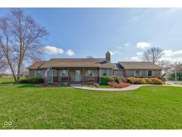 Charming brick home with a covered front porch, landscaped lawn, and mature trees at 9377 N 500 W, McCordsville, IN 46055