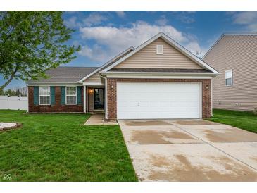 Charming single-Gathering home with brick accents, a two-car garage, and well-maintained landscaping at 2260 Quarter Path Rd, Cicero, IN 46034