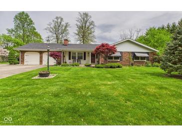 Charming ranch-style home featuring a brick exterior, well-manicured lawn, and mature trees at 3824 Oakwood Blvd, Anderson, IN 46011