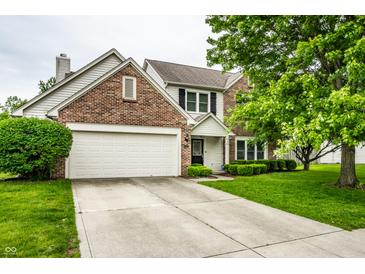 Charming two-story brick home featuring an attached two-car garage and a well-maintained front yard at 4227 Short Ter, Carmel, IN 46033