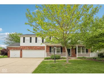 Charming two-story home with brick accents, white siding, covered porch, and a well-manicured front lawn at 5 Statesman Ct, Brownsburg, IN 46112