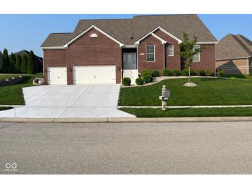 Charming brick home with a well-manicured lawn and an inviting entrance, plus a two-car garage at 5601 Harness Dr, Greenwood, IN 46143