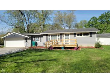 Charming single-story home with a wooden front porch and manicured lawn at 5831 Aho Dr, Avon, IN 46123