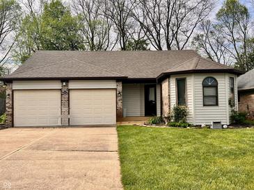 Charming single-story home featuring a two-car garage and a well-manicured lawn at 741 Springmill Dr, Mooresville, IN 46158