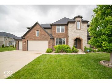 Stunning two-story brick home featuring a spacious front yard with a long driveway at 9949 Stable Stone Ter, Fishers, IN 46040