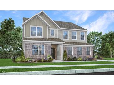 Charming two-story home featuring a combination of brick and siding, surrounded by a well-maintained lawn and garden at 1103 Marston Ln, Avon, IN 46123