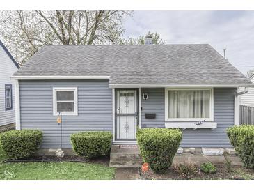 Charming single-story home with gray siding, trimmed hedges, and a well-maintained front yard at 1643 E Tabor St, Indianapolis, IN 46203