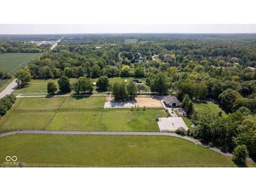 Sprawling equestrian estate showcasing pastures, riding arena, trees, and home at 2450 S Us 421, Zionsville, IN 46077