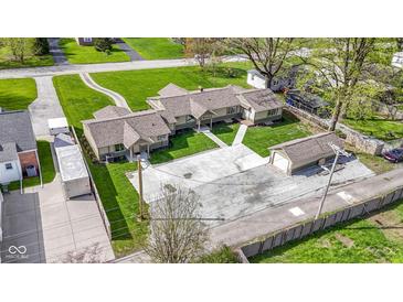 Charming single story home with a detached garage and a large concrete driveway perfect for multiple vehicles at 32 W Michigan St, Greenfield, IN 46140
